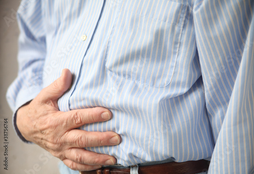 businessman with indigestion or stomach pain photo