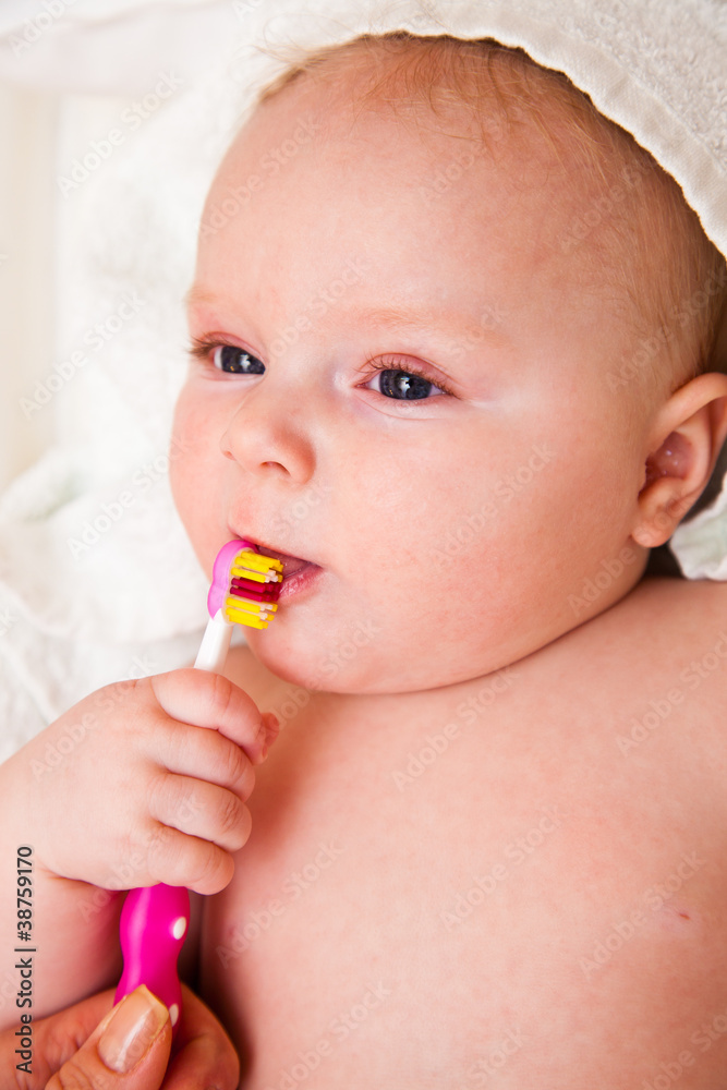 Infant with toothbrush