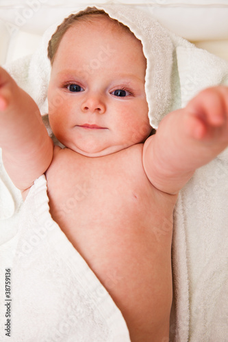Cute infant girl happy in white towel