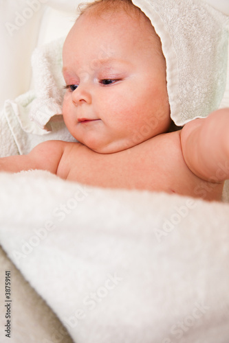 Cute infant girl happy in white towel