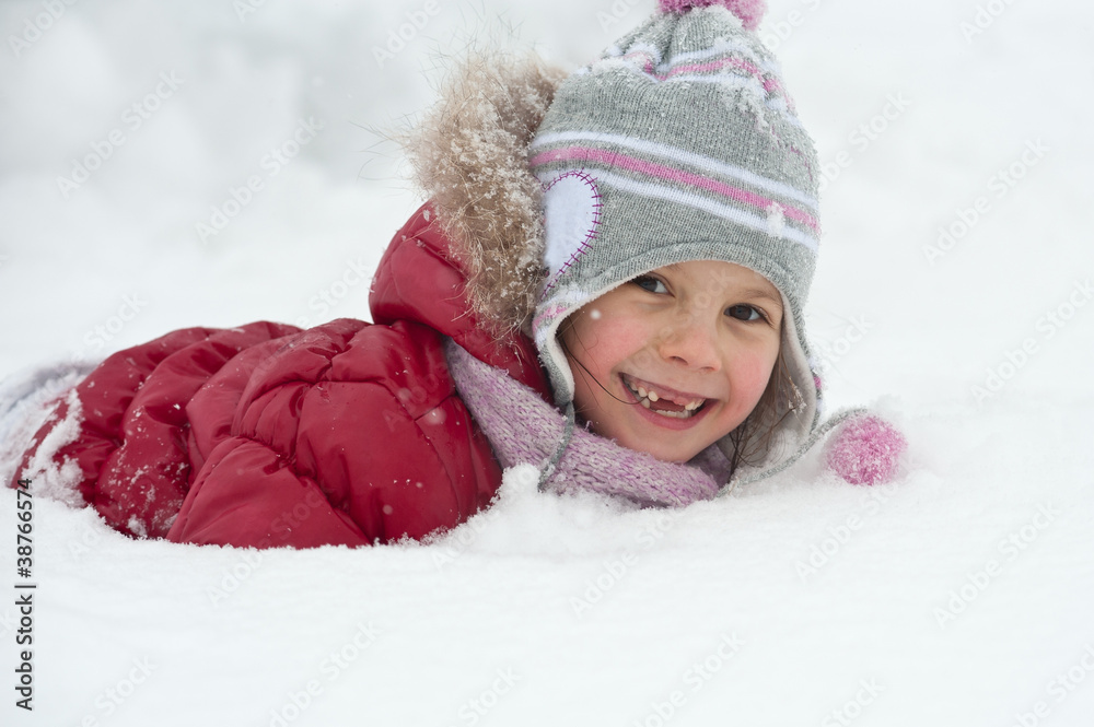 Young girl playing in the snow. Young girl playing in the snow.