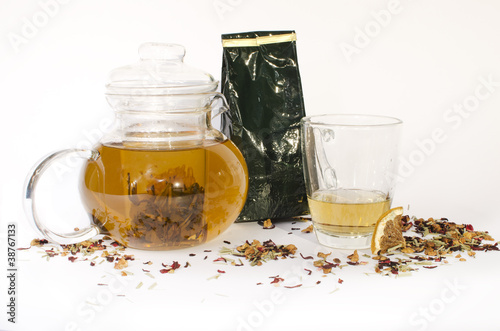 A Jar, a glass and bunch of tea photo