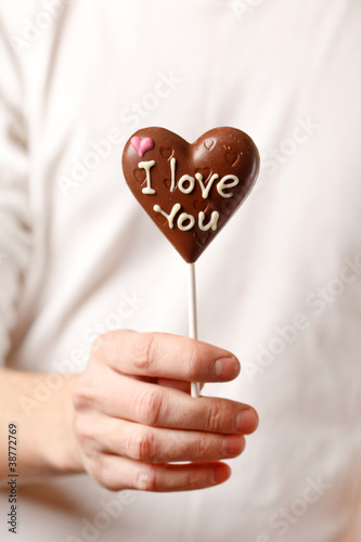 man with chocolate heart in the hands