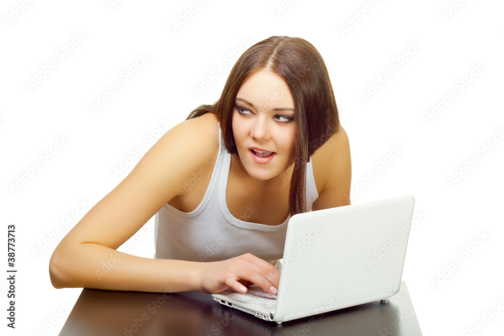 The young woman with the laptop behind a table The young woman with the laptop behind a table