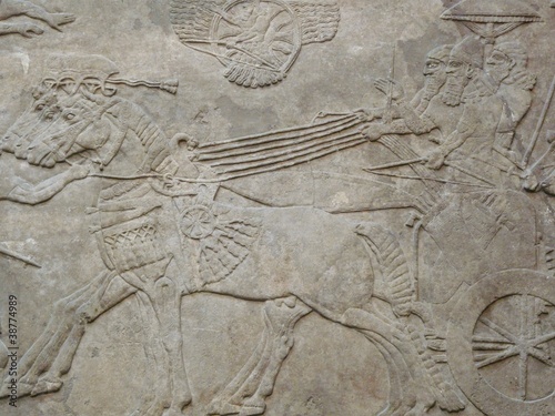 Ancient Assyrian wall carvings of men and horses