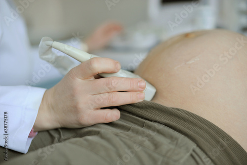 Closeup of hand scanning with ultrasound