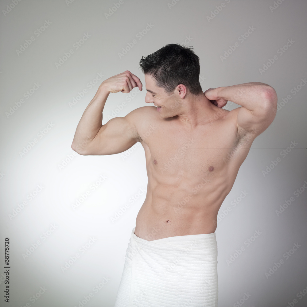 Naklejka premium young muscle man admiring himself