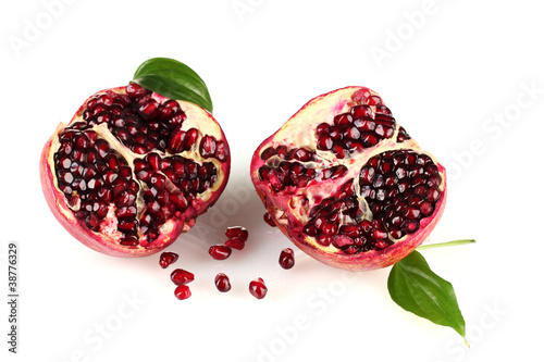 ripe pomegranate fruit with leaves isolated on white photo