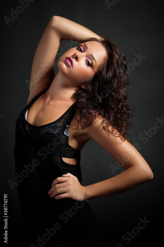 Sexy brunette girl on dark background