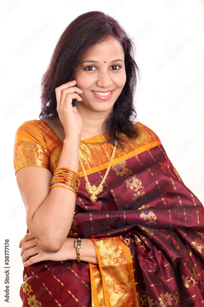 Traditional young Indian woman talking on cellphone Traditional young Indian woman talking on cellphone