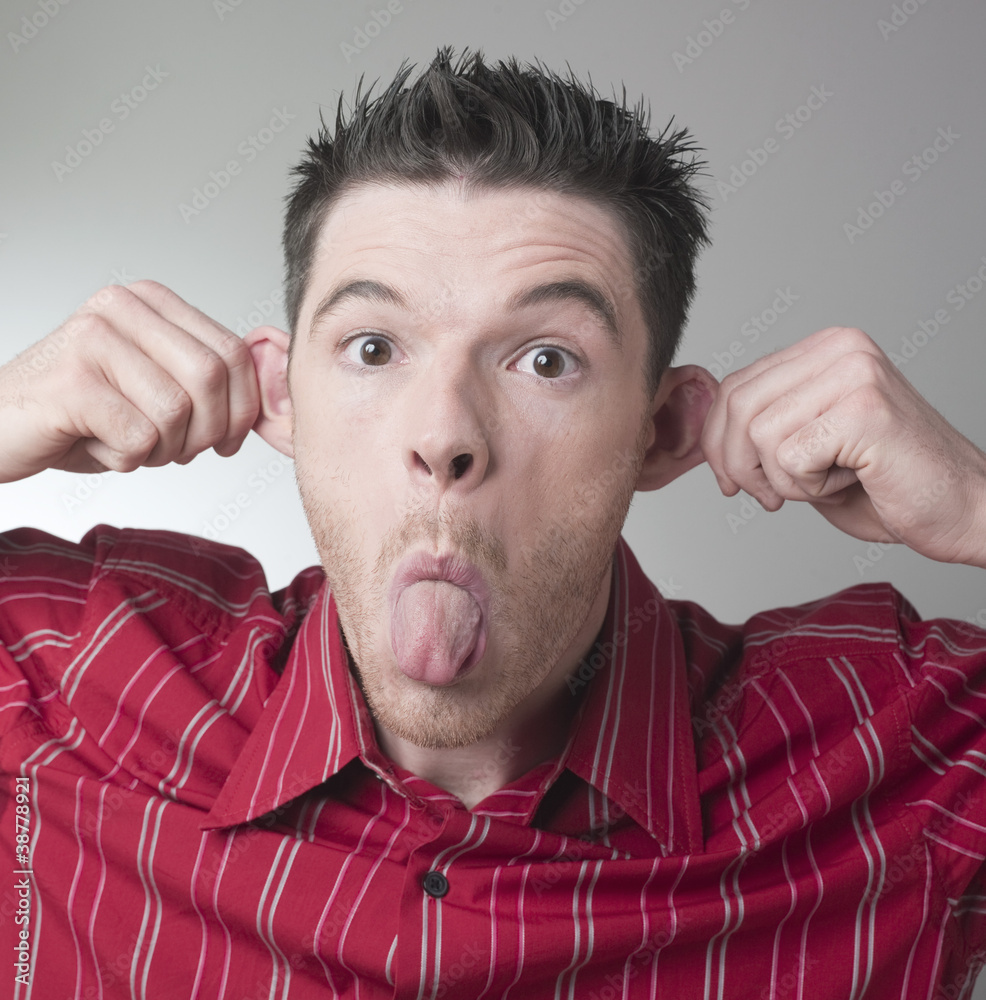 funny man sticking out his tongue and ears Stock Photo Adobe Stock