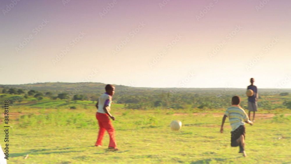 Children playing soccer on the fields in Kenya. Children playing soccer on the fields in Kenya.