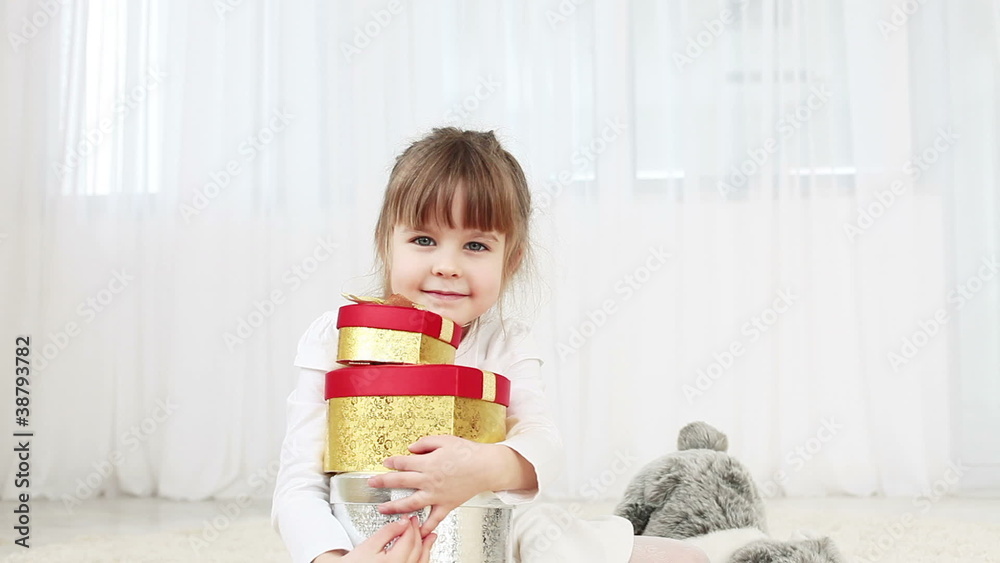 Young girl with gifts on the floor Young girl with gifts on the floor