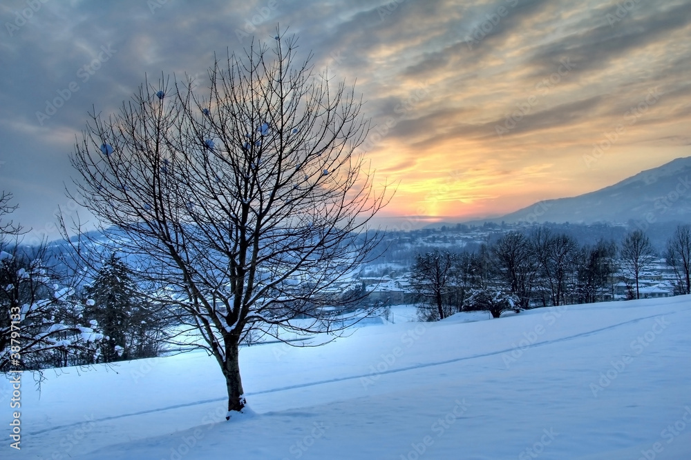 Winter sunset from snowy fields over italian alpine village Winter sunset from snowy fields over italian alpine village
