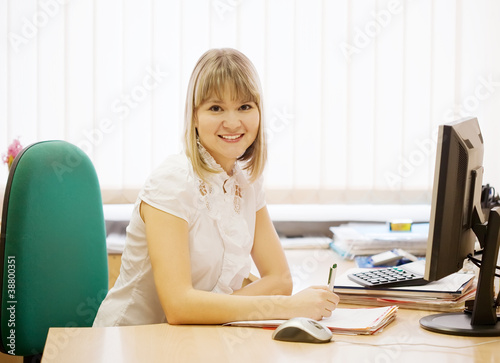 businesswoman writing on her  workplac photo