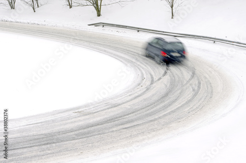 snowfall on the road, slippery way with car