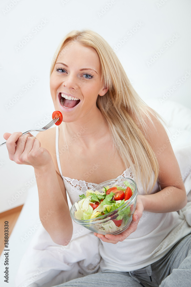 Beautiful woman eating green salad Beautiful woman eating green salad