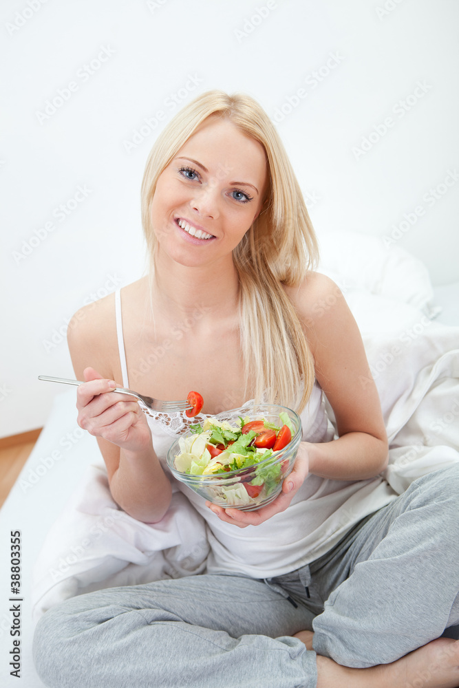 Beautiful woman eating green salad Beautiful woman eating green salad
