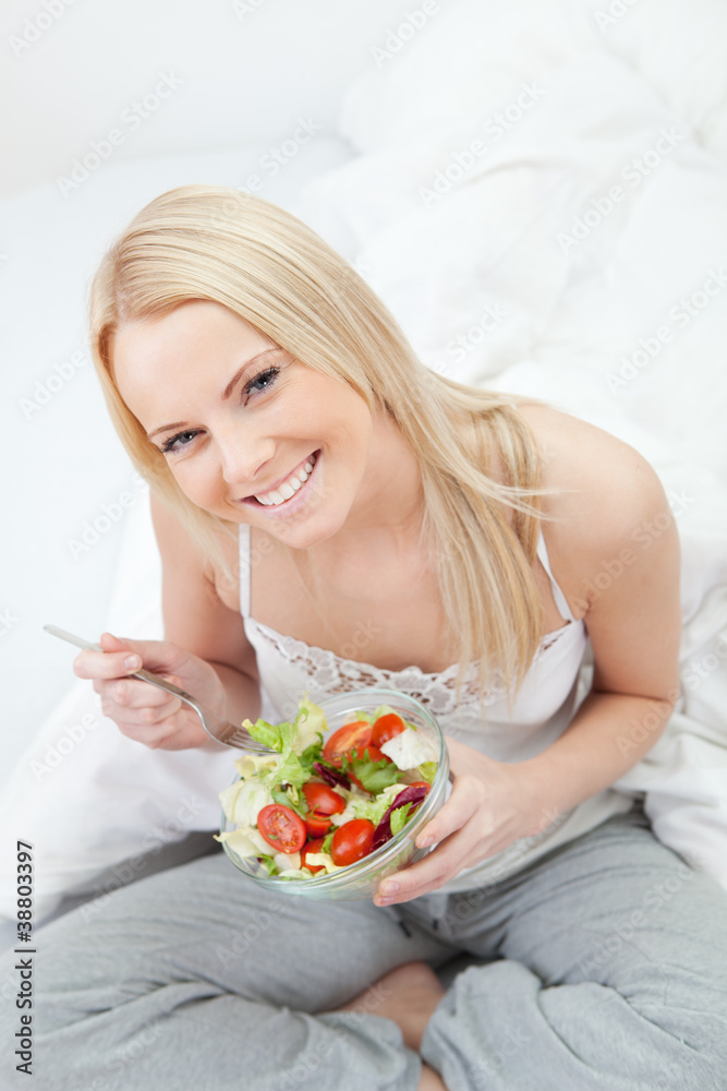 Beautiful woman eating green salad Beautiful woman eating green salad