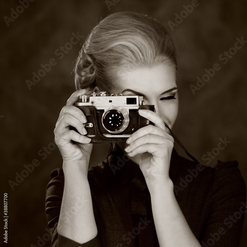 Woman in classic dress with retro camera.