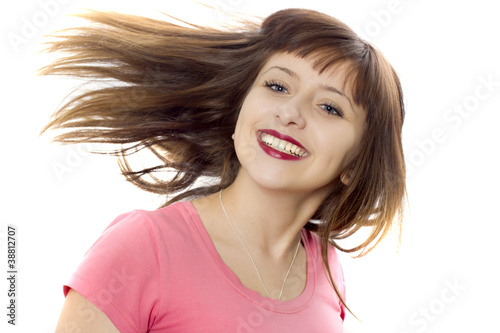 The portrait of the girl on a white background which smiles photo