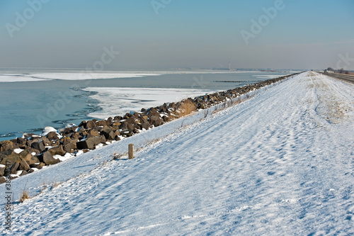 Fototapeta Naklejka Na Ścianę i Meble -  Frozen lake along a dam, Almere, Netherlands