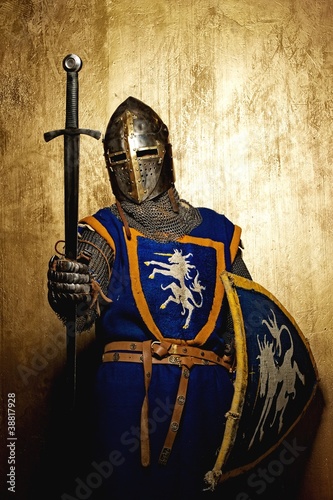 Medieval knight on golden background.