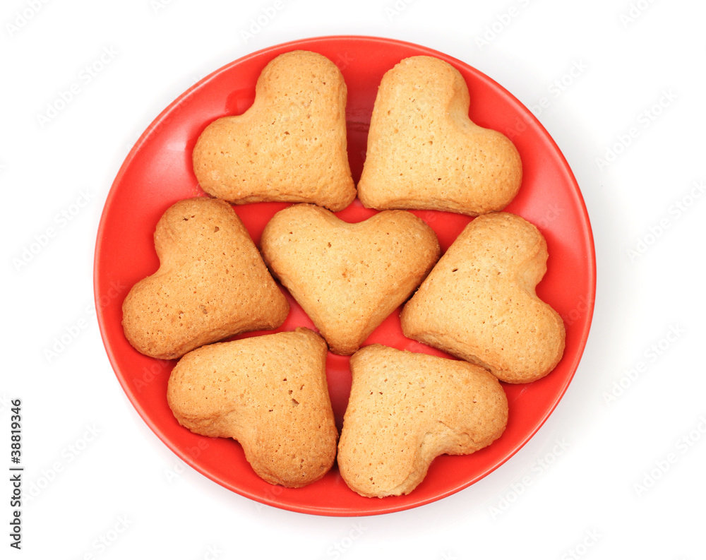 Heart-shaped cookies on red saucer isolated on white Heart-shaped cookies on red saucer isolated on white