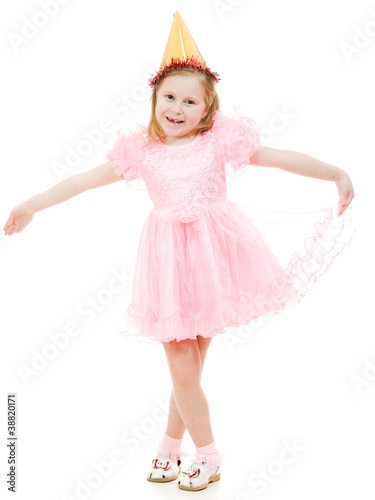 A girl in a pink dress and hat dances on a white background.