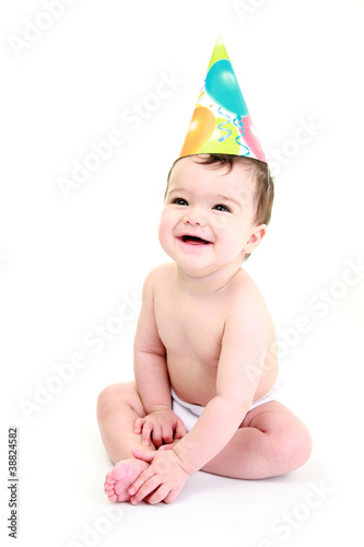 Laughing baby wearing party hat - celebration