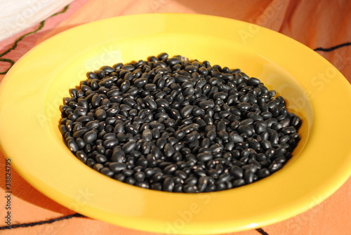 black beans in a yellow dish