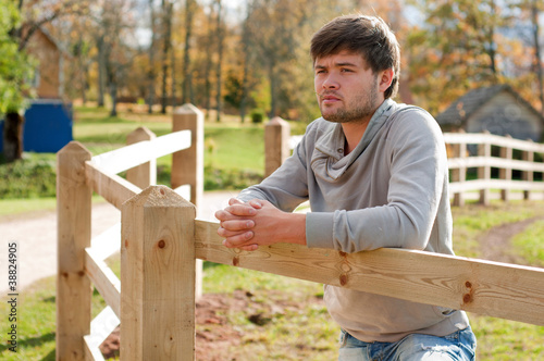 Portrait of young guy in country field