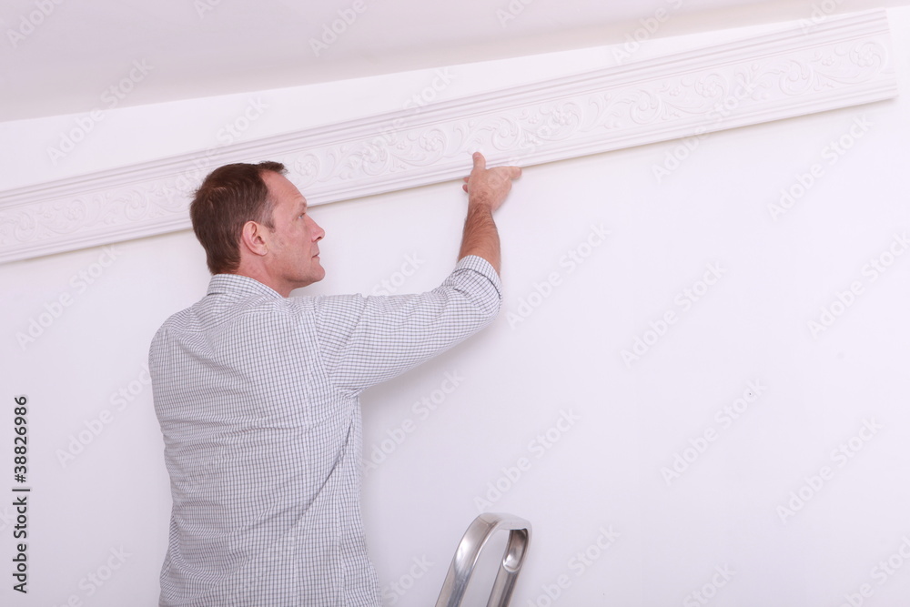 man fixing something on a wall man fixing something on a wall