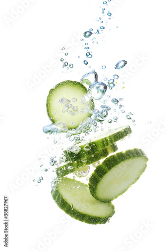 fresh sliced cucumber in water isolated on white