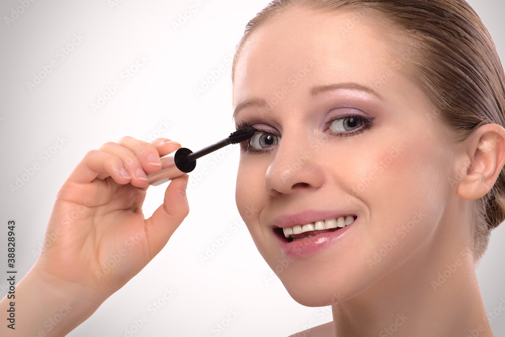beauty girl paints the eyelashes makeup mascara