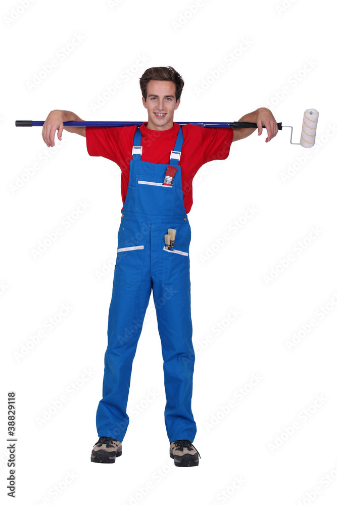 Young decorator with a ceiling roller Young decorator with a ceiling roller