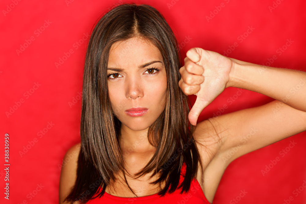 Unhappy thumbs down woman Unhappy thumbs down woman