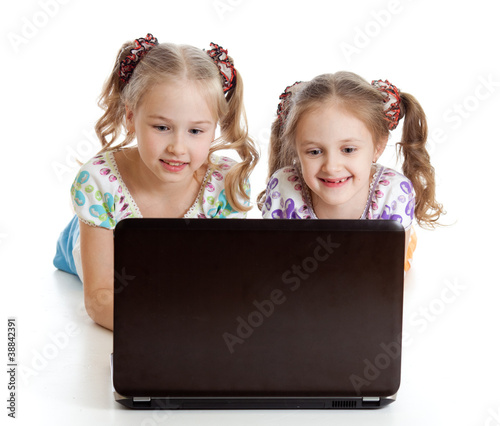 smart girlfriends smiling and looking at the laptop