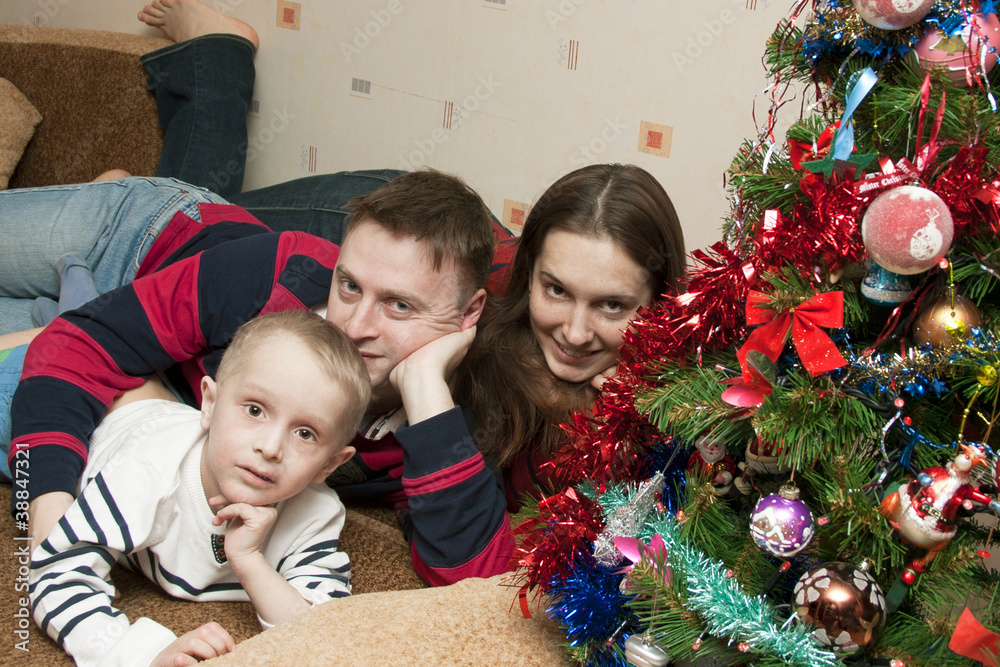 Family of three at home celebrating Christmas Family of three at home celebrating Christmas