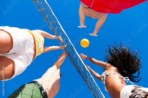 Friends playing beach volleyball photo