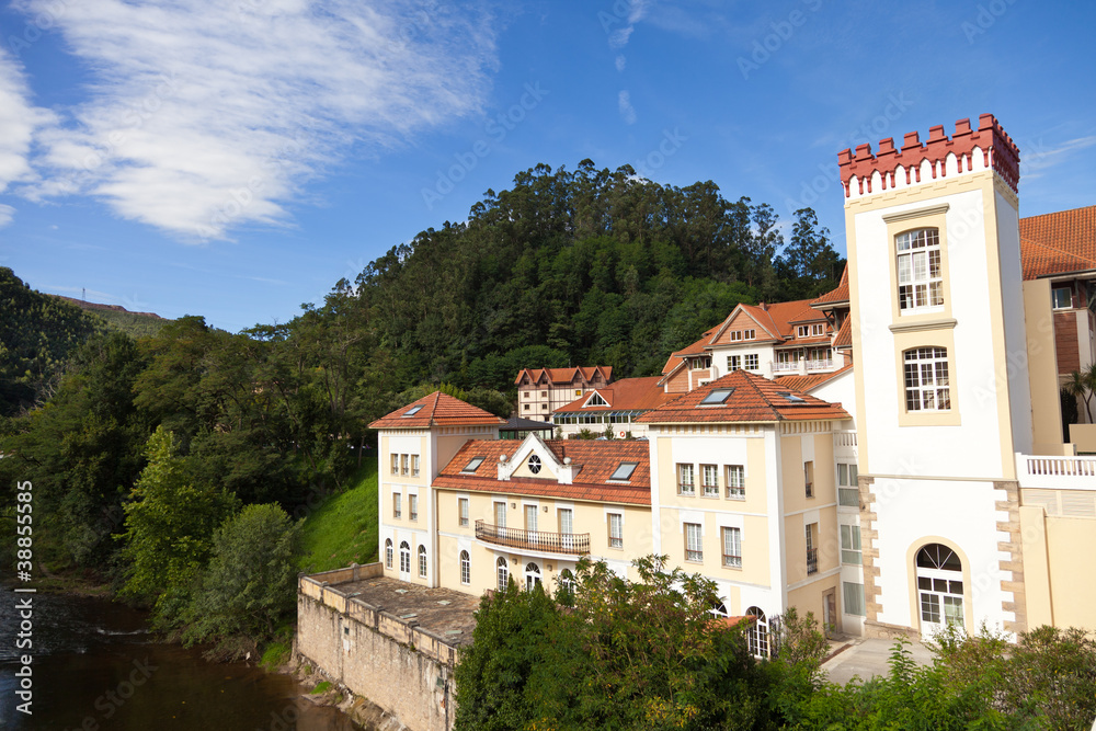 Grand old spa resort next to a river surrounded by forests Grand old spa resort next to a river surrounded by forests