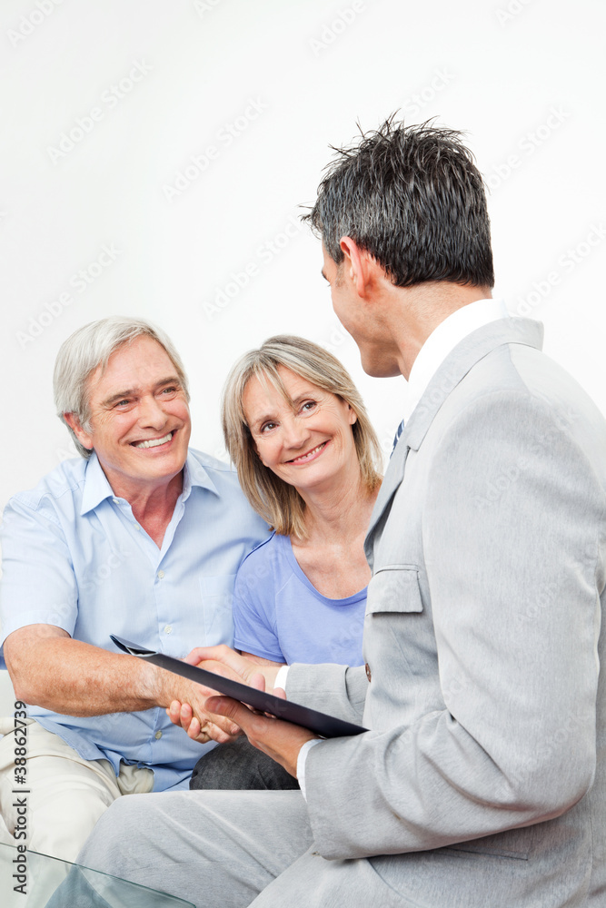 Seniorenpaar begrüßt Anlageberater
