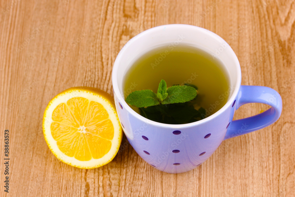Mint tea with mint leaf and lemon on wooden background Mint tea with mint leaf and lemon on wooden background