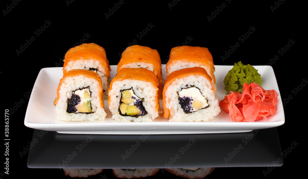 Tasty rolls served on white plate isolated on black Tasty rolls served on white plate isolated on black