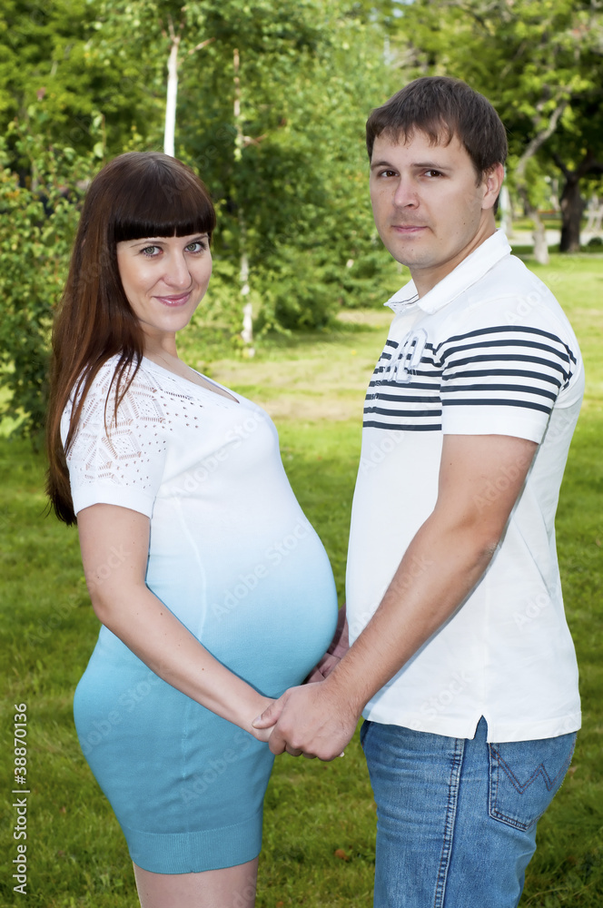 Man and a pregnant woman in the park