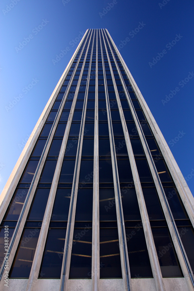 Generic office Tower rising Dozens of Floors into the Blue Sky Generic office Tower rising Dozens of Floors into the Blue Sky