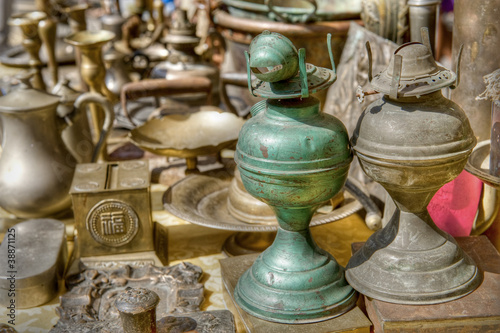 Brass antiques at a market stall. High dynamic range image.