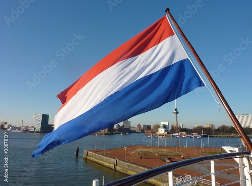 The dutch flag on a ship in the river Meuse in Rotterdam