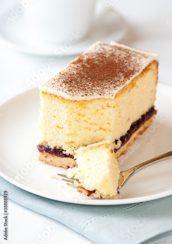 Piece of cheesecake with white chocolate and cocoa