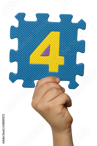 Children hand holding the number Four. White isolated number